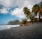Dramatic seascape landscape of the beautiful wild tropical Diamant beach with its layered woman mountain, dark sand and