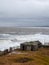 Dramatic seascape with a raging White sea and a fishing hut on the shore. Kandalaksha bay