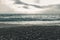 Dramatic seascape with waves in front of shingle beach