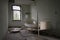 Dramatic shot of an abandoned prison room with a broken bed and weathered windows