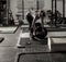 Dramatic shot of female weight lifter loading weights onto barbell