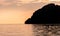 Dramatic Silhouette of mountains and boats in the middle of andaman sea near Phi Phi Islands during sunset