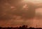 Dramatic sky between clouds in the late afternoon and the silhouette of a factory in southern Brazil