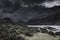 Dramatic sky with dark clouds over scenic mountain valley in Lake District, England