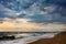 Dramatic sky on a morning seascape. Storm on sandy sea beach.