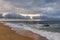 Dramatic sky on a morning seascape. Storm on sandy sea beach.
