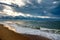 Dramatic sky on a morning seascape. Sunrise on a sandy beach.