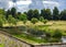 Dramatic sky over English countryside stream; overlooking wall