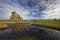 Dramatic sky over the marsh and the St Thomas Becket Church in Fairfield Kent UK