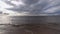Dramatic sky panorama over sandy beach and sea. Beautiful seascape