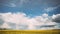 Dramatic Sky With Rain Clouds And Rainbow On Horizon Above Rural Landscape Camola Colza Rapeseed Field. Agricultural And