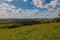 A dramatic sky in Spring above the hills with the typical Tuscany Cypress trees in south Limburg in the Netherlands, makes you fee