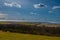 A dramatic sky in Spring above the hills with the typical Tuscany Cypress trees in south Limburg in the Netherlands, makes you fee