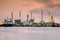 Dramatic sky during sunrise, Petrol chemical refinery industry plant waterfront