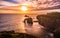 Dramatic sky at sunset with Enys Dodnan and the Armed Knight rock formations at Lands End