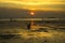 dramatic sky during sunset with rocks and boats foreground in Bangkalan, Madura, Indonesia.