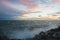 Dramatic splashing ocean wave in the evening with twilight sky in Winter at breakwater at St Kilda pier in Melbourne Australia