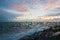 Dramatic splashing ocean wave in the evening with twilight sky in Winter at breakwater at St Kilda pier in Melbourne Australia