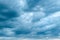 Dramatic stormy cumulus clouds at the sky in spring dusk