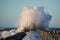 Dramatic, strong waves and foam spray hit the pier in Vorupoer on the North Sea coast of Denmark