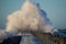 Dramatic, strong waves and foam spray hit the pier in Vorupoer on the North Sea coast of Denmark