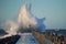 Dramatic, strong waves and foam spray hit the pier in Vorupoer on the North Sea coast of Denmark