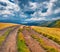 Dramatic summer scene of Svydovets mountain range with old country road.