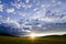 Dramatic summer sunset with scattered cloudson a crops meadow, Mongolia