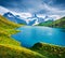 Dramatic summer view of the Bachalpsee lake with Schreckhorn peak on background. Picturesque morning scene of Swiss Bernese Alps,