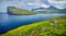 Dramatic summer view of Eidi village. Rainy morning scene of Eysturoy island. Green landscape of Faroe Islands, Denmark, Europe. B