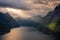 Dramatic sunbeam from the clouds over the Geirangerfjord,  Norway