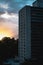 Dramatic sunbeams behind the Residential Building With Reflections in a Windows, Background Photo