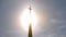 Dramatic sunlight behind church cross