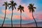 Dramatic sunrise with Lanai and palm trees.