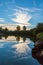 Dramatic sunrise on tranquil lake with reflections trees