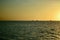 Dramatic sunset colours; beautiful sunset on a beach. Sun reflection in the water, with yacht silhouettes far away