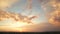 Dramatic sunset landscape picture with puffy clouds lit by orange setting sun and blue sky.