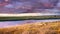 Dramatic sunset landscape with storm clouds reflected in the restored wetlands of South San Francisco Bay Area; Mountain View,