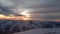 Dramatic sunset in the mountain. Cloudy sky at sunset. High mountain snowy landscape