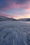 Dramatic sunset over the icy lake in the Arctic tundra. Yamal peninsula.