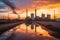 Dramatic sunset over industrial refinery mirrored in water