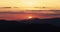 Dramatic sunset over mountain hills, aerial view
