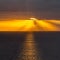 Dramatic sunset over North Sea bathed in golden sunbeams