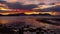 Dramatic sunset over ocean and mountains, Epic warm clouds in sky moving in timelapse, Iceland