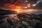 dramatic sunset over rocky shoreline, with clouds and sky transitioning from day to night