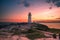 A dramatic sunset at Peggy\'s Cove Lighthouse, Atlantic Coast, Nova Scotia, Canada.