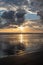 Dramatic Sunset  with Relections on a sandy beach