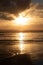 Dramatic Sunset  with Relections on a sandy beach