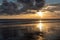 Dramatic Sunset  with Relections on a sandy beach