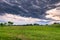 Dramatic sunset sky over the flowered Bogolyubovo meadow, Vladimir region, Russia. Picturesque peaceful corner of nature away from